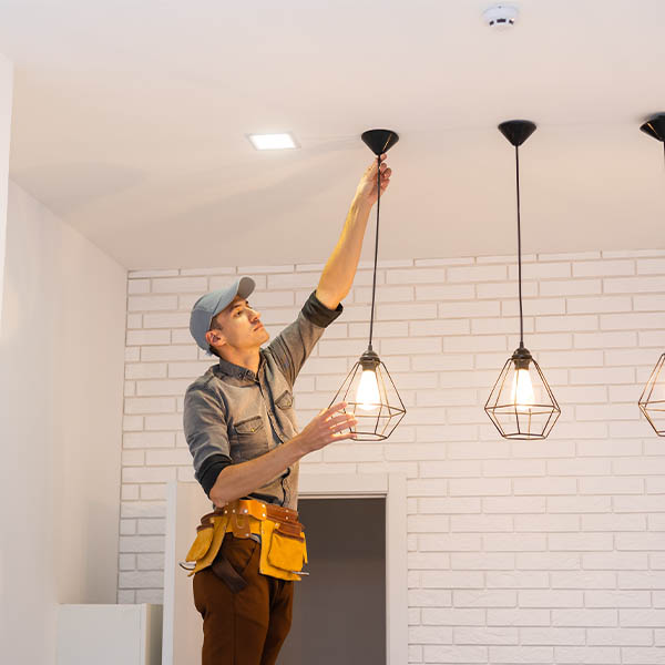 Photo of an electrician installing celling lights