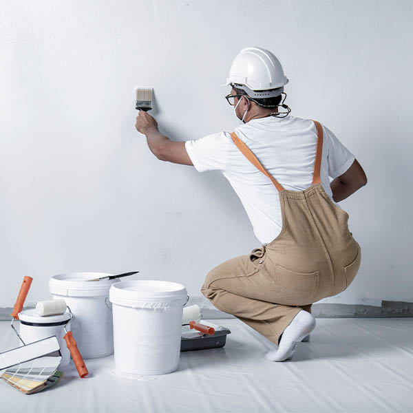 Photo of a painter decorator painting a wall.